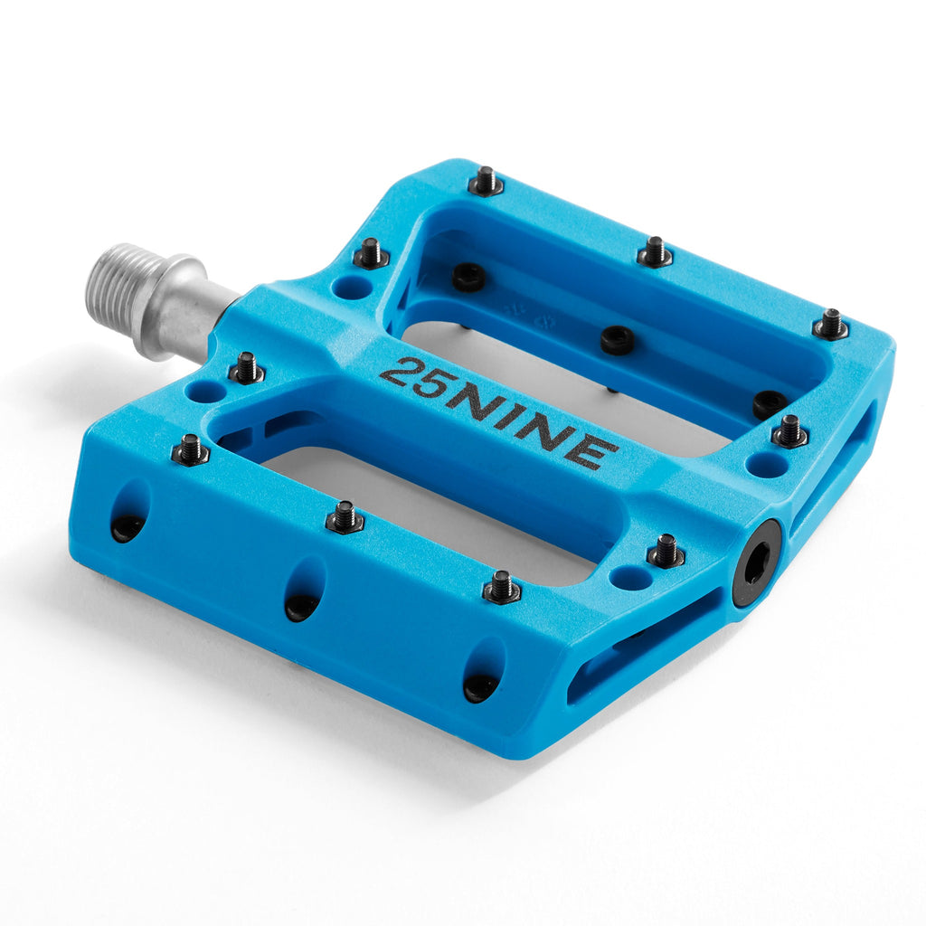 High traction bike pedal with removable pins. Blue pedal from a corner view on a white background.
