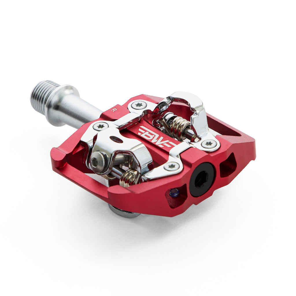 Red clipless mountain bike pedal, corner view on white background. SPD compatible bicycle pedal.