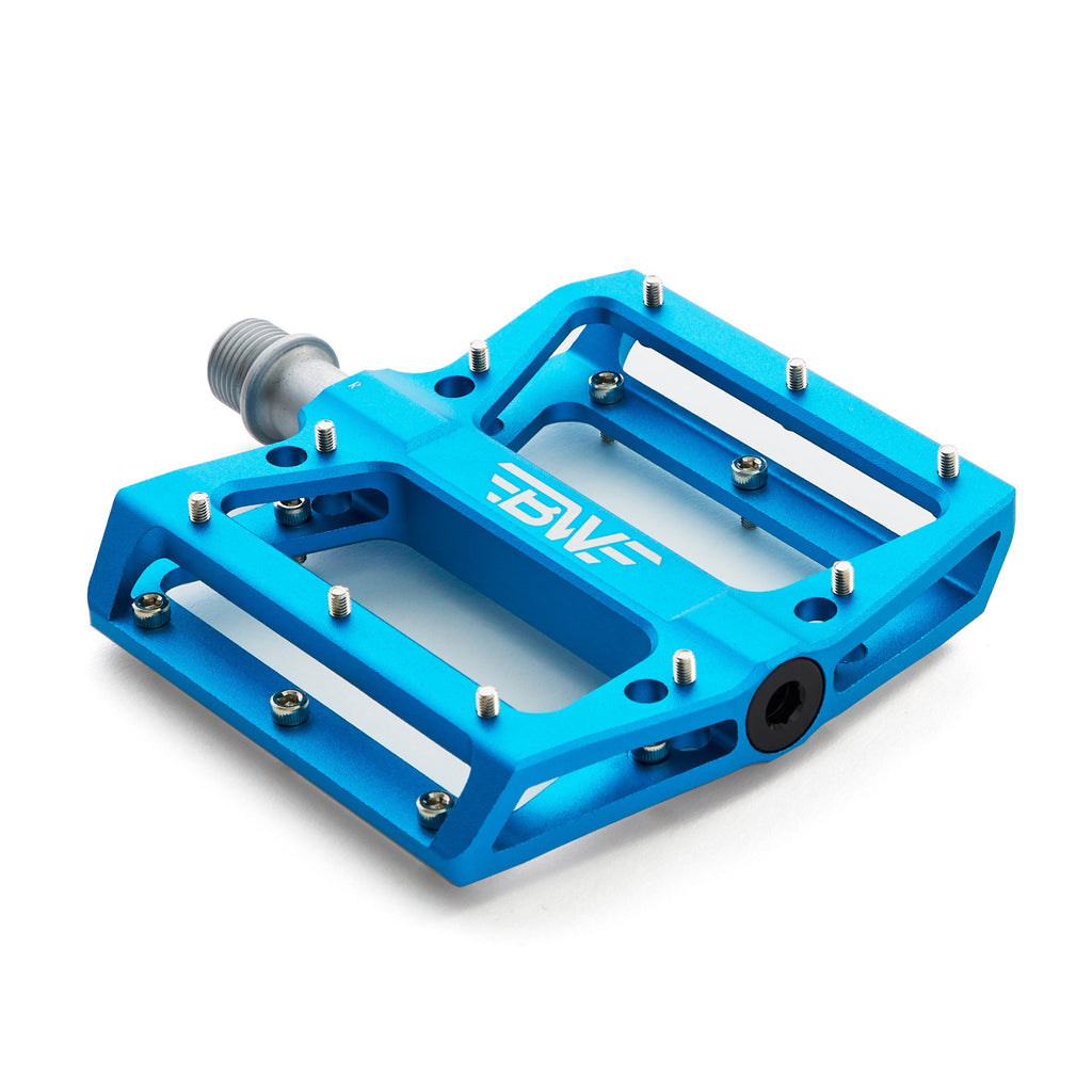 Large platform mountain bike pedal with replaceable traction pins.  Blue mountain bike pedal viewed from corner on white background.