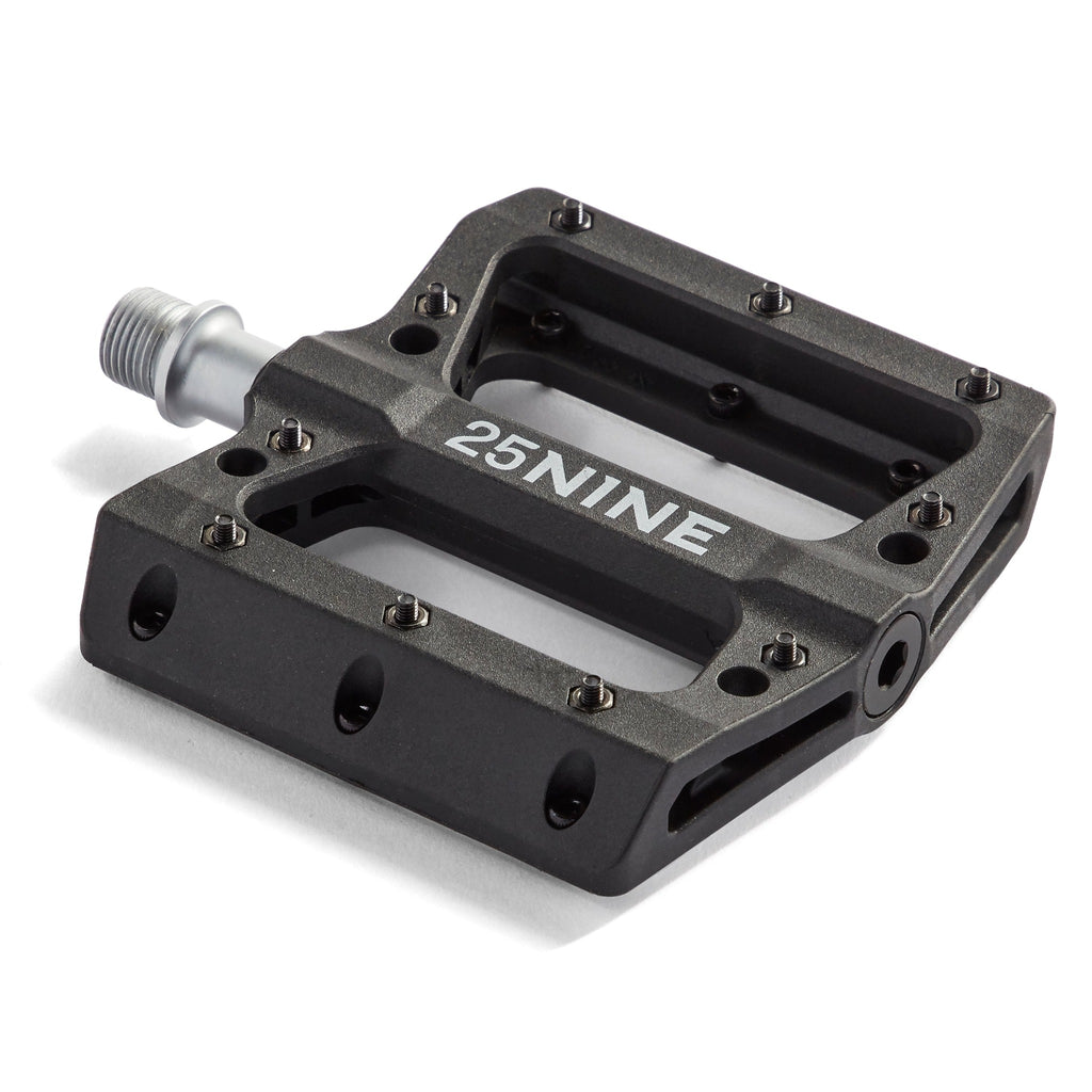 High traction bike pedal with removable pins. Black pedal from a corner view on a white background.