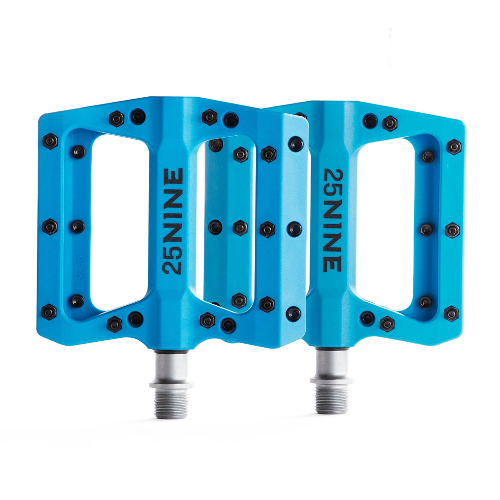 High traction bike pedals with removable pins. Blue pedal from a top view on a white background.