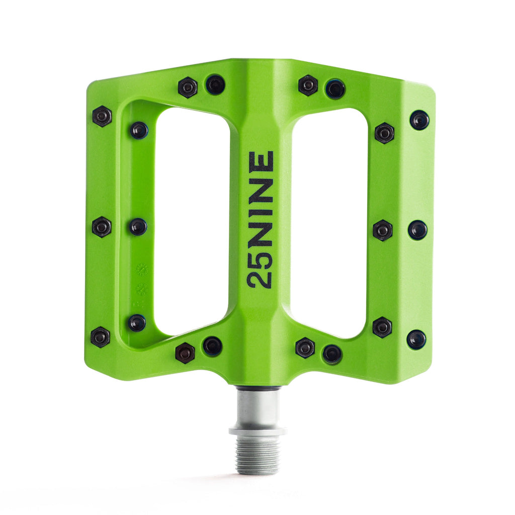 High traction bike pedal with removable pins. Green bike pedal from a top view on a white background.