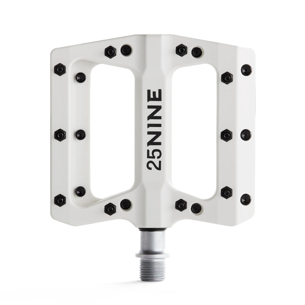 High traction bike pedal with removable pins. White bike pedal from a top view on a white background.