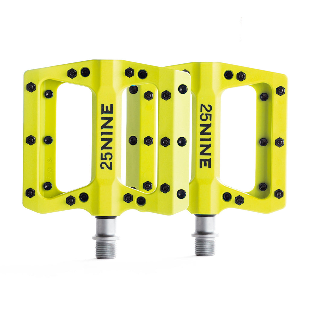 High traction bike pedals with removable pins. Yellow bike pedals from a top view on a white background.