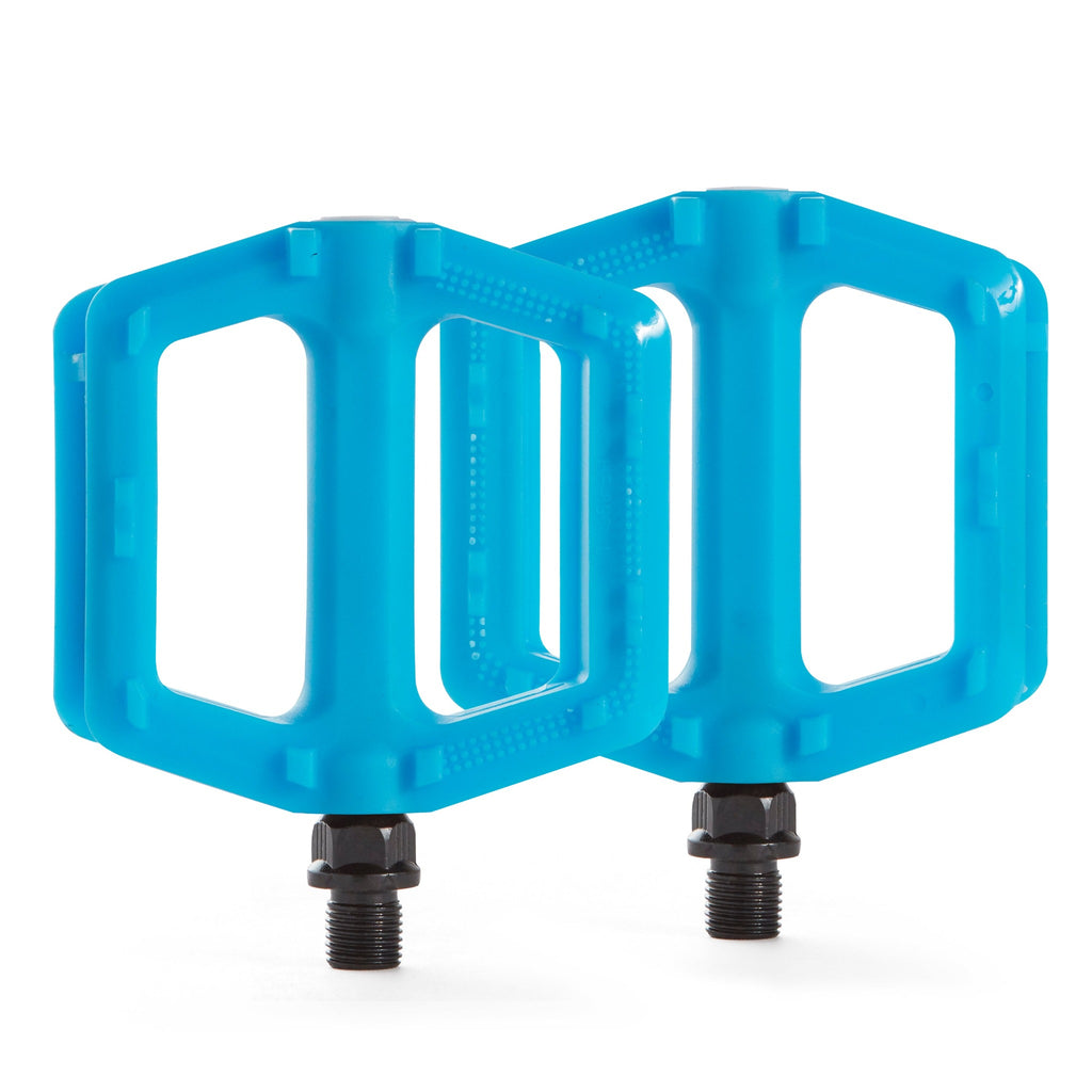 Two blue bike pedals for kids. Two pedals with a white background.
