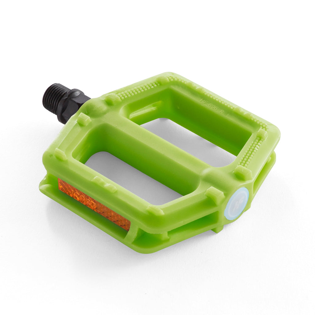 A single green bike pedal for kids. Angled overhead view with a white background.