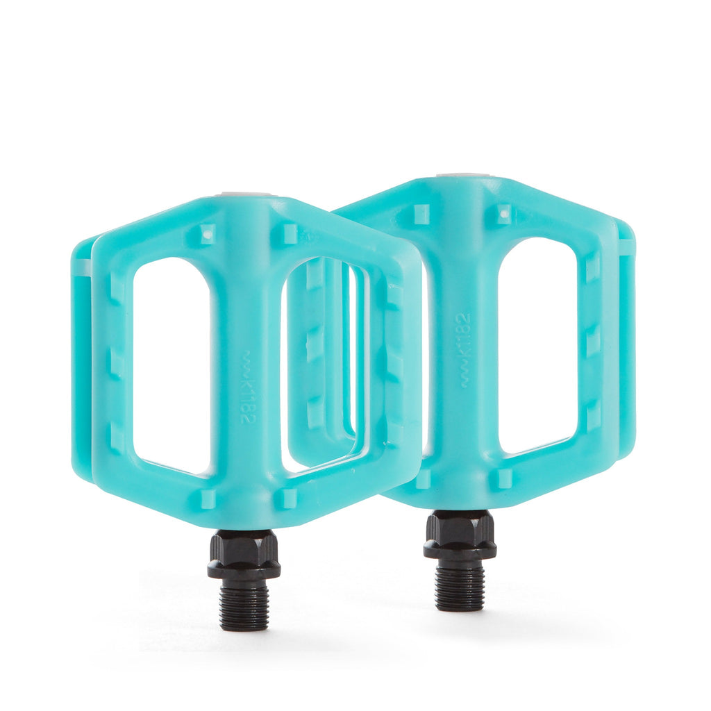 Seafoam blue bike pedals for kids. Top down view with white background.