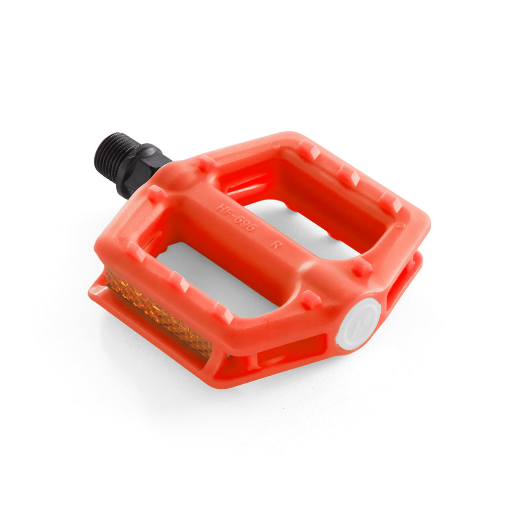 Kids orange bike pedals. Angled side view with white background