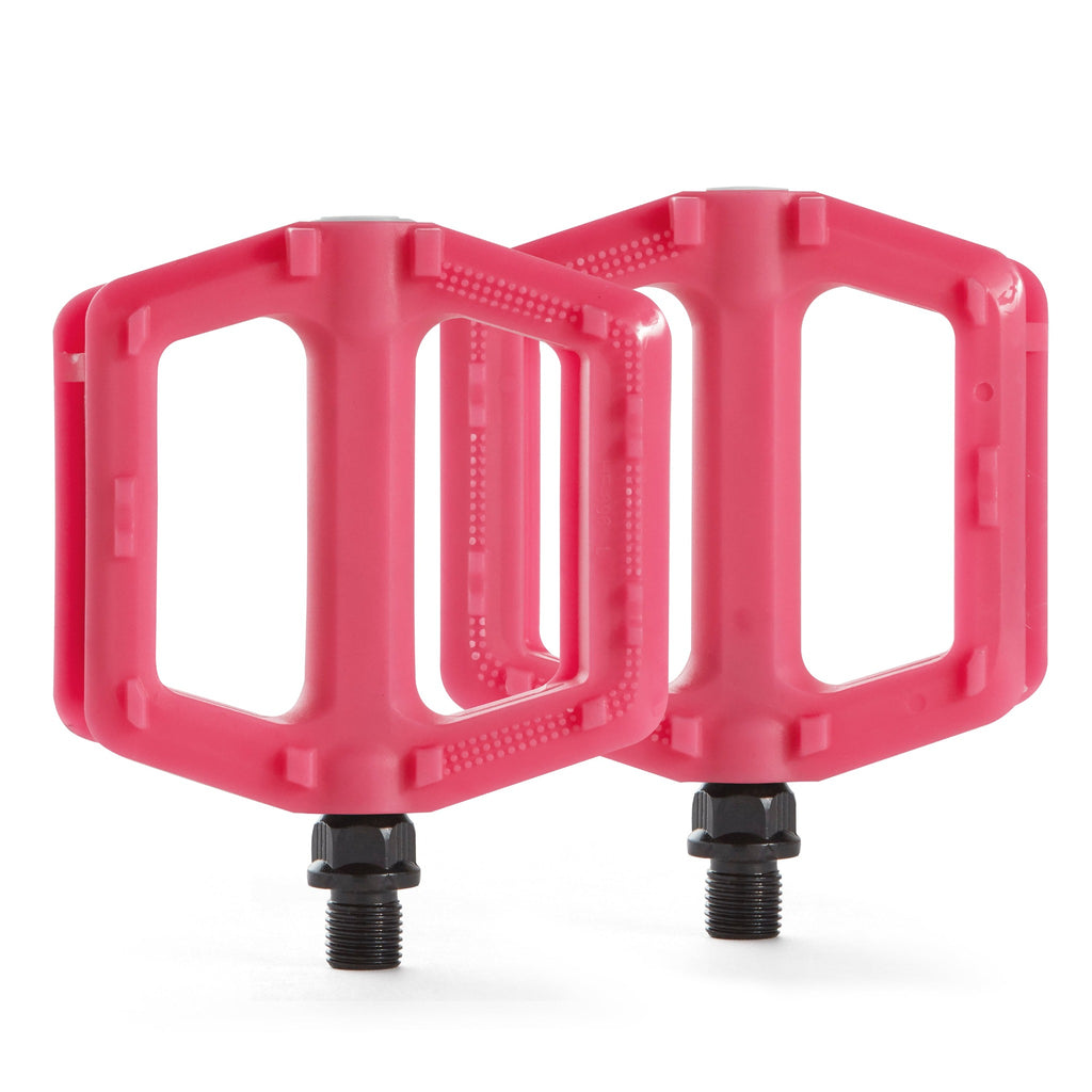 Two pink bicycle pedals for kids. Overhead view with a white background.