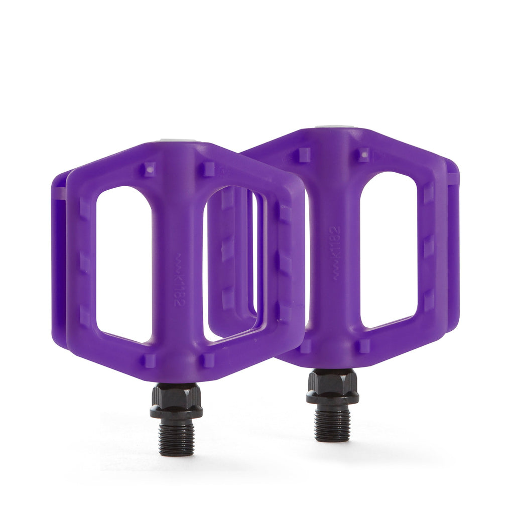Kids bike pedals in the color purple. Top down view with white background.
