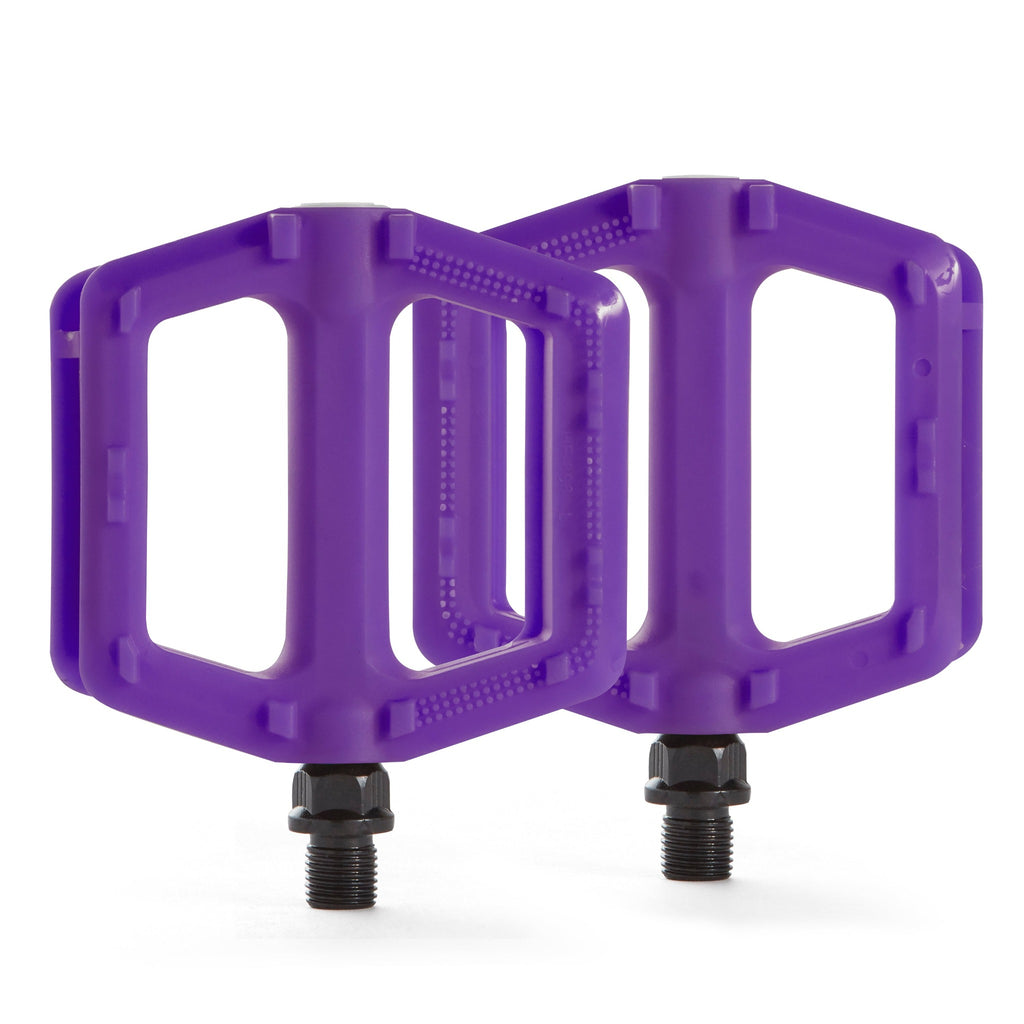 Purple bike pedals for kids. Overhead view with a white background.
