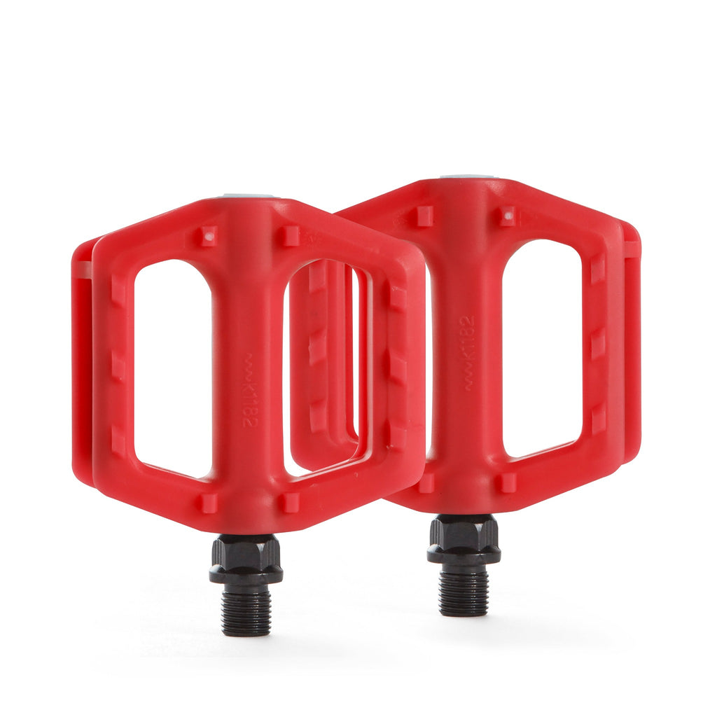Kids bike pedals in the color red. Top down view with white background.