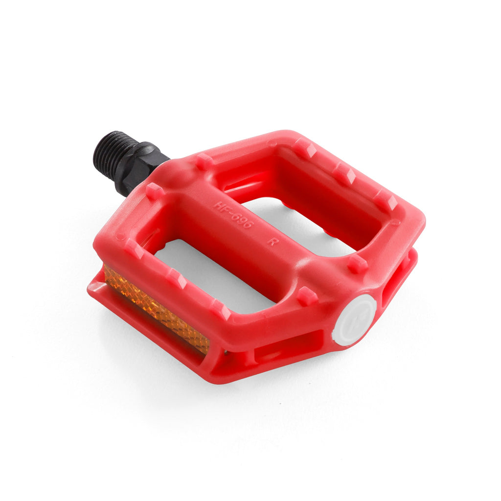 Kids bike pedal in the color red. Angled down view with white background.