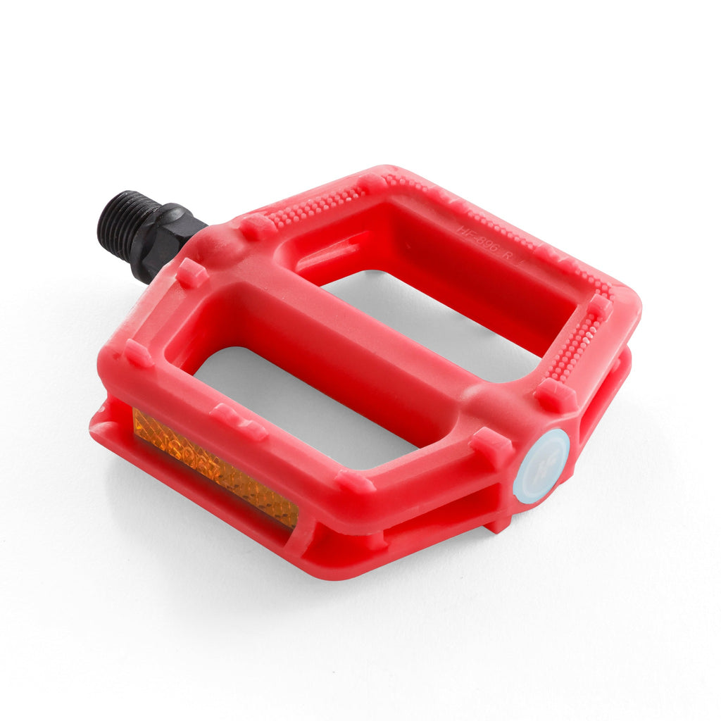Kids red bike pedal with light reflectors. Corner view with a white background.