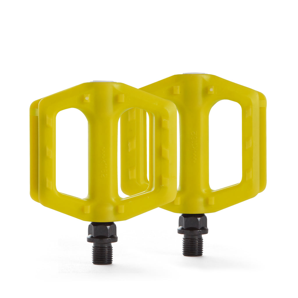 Yellow bike pedals for kids. Top down view with white background.