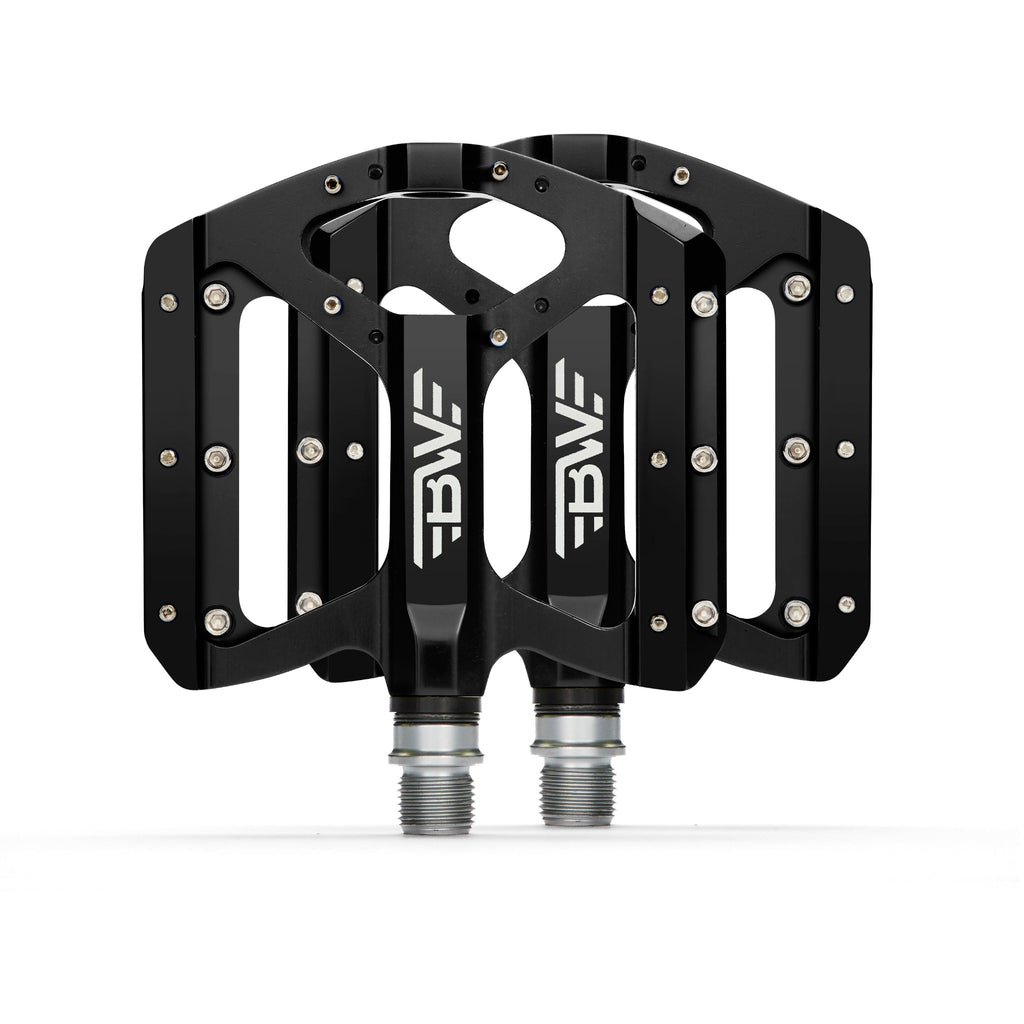Black mountain bike pedals on white background. Top view of mountain bike pedals.