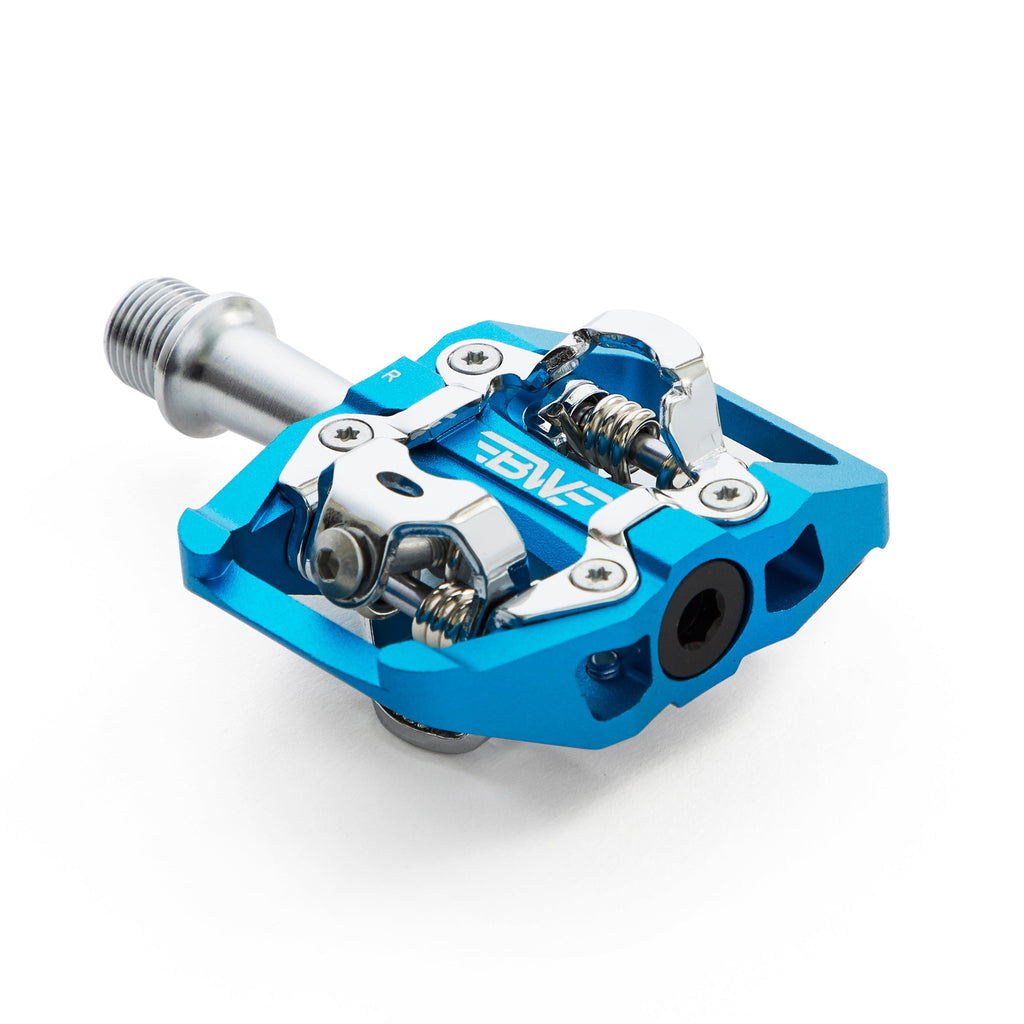 Blue clipless mountain bike pedal, corner view on white background. SPD compatible bicycle pedal.