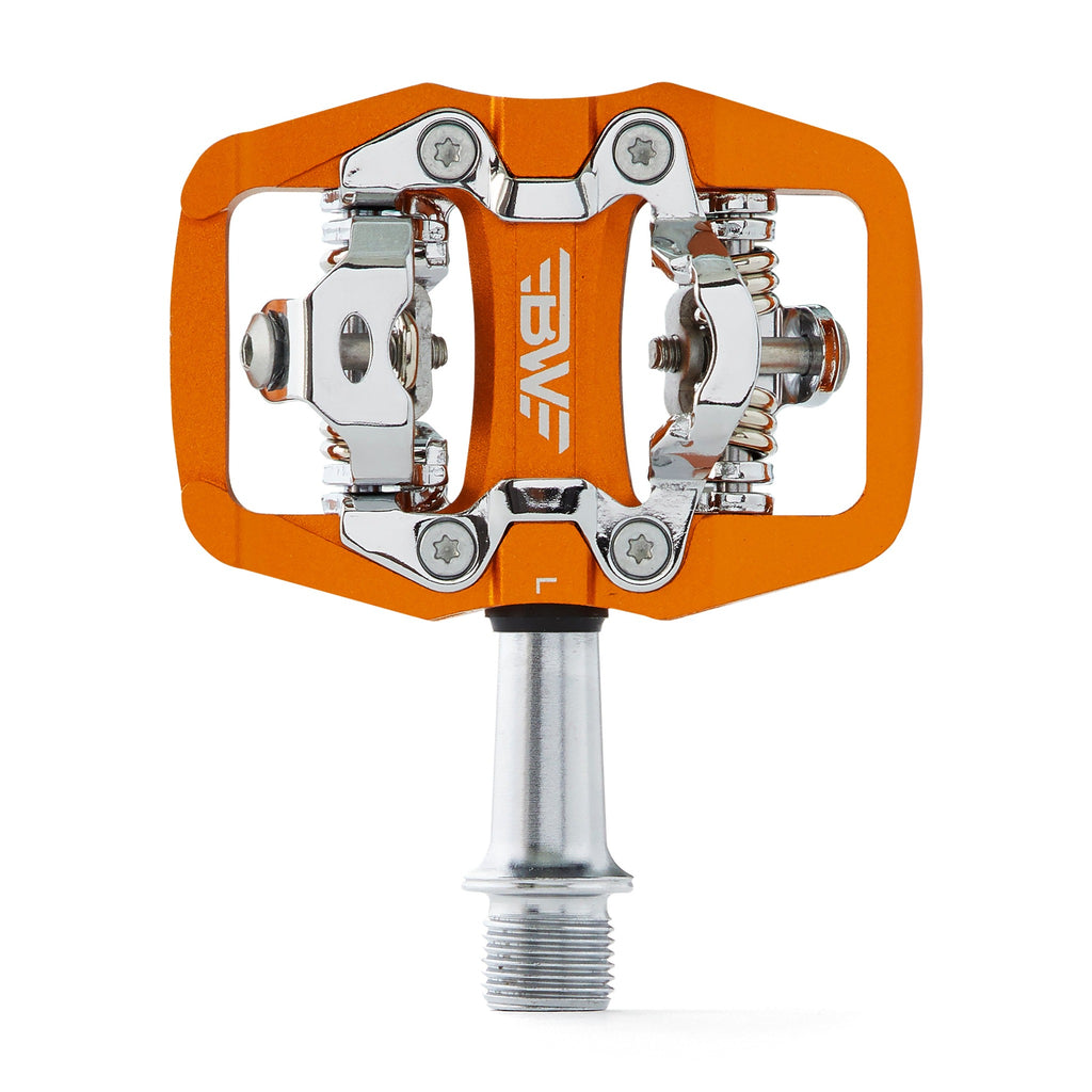 Orange clipless mountain bike pedal, top view on white background. SPD compatible bicycle pedal.