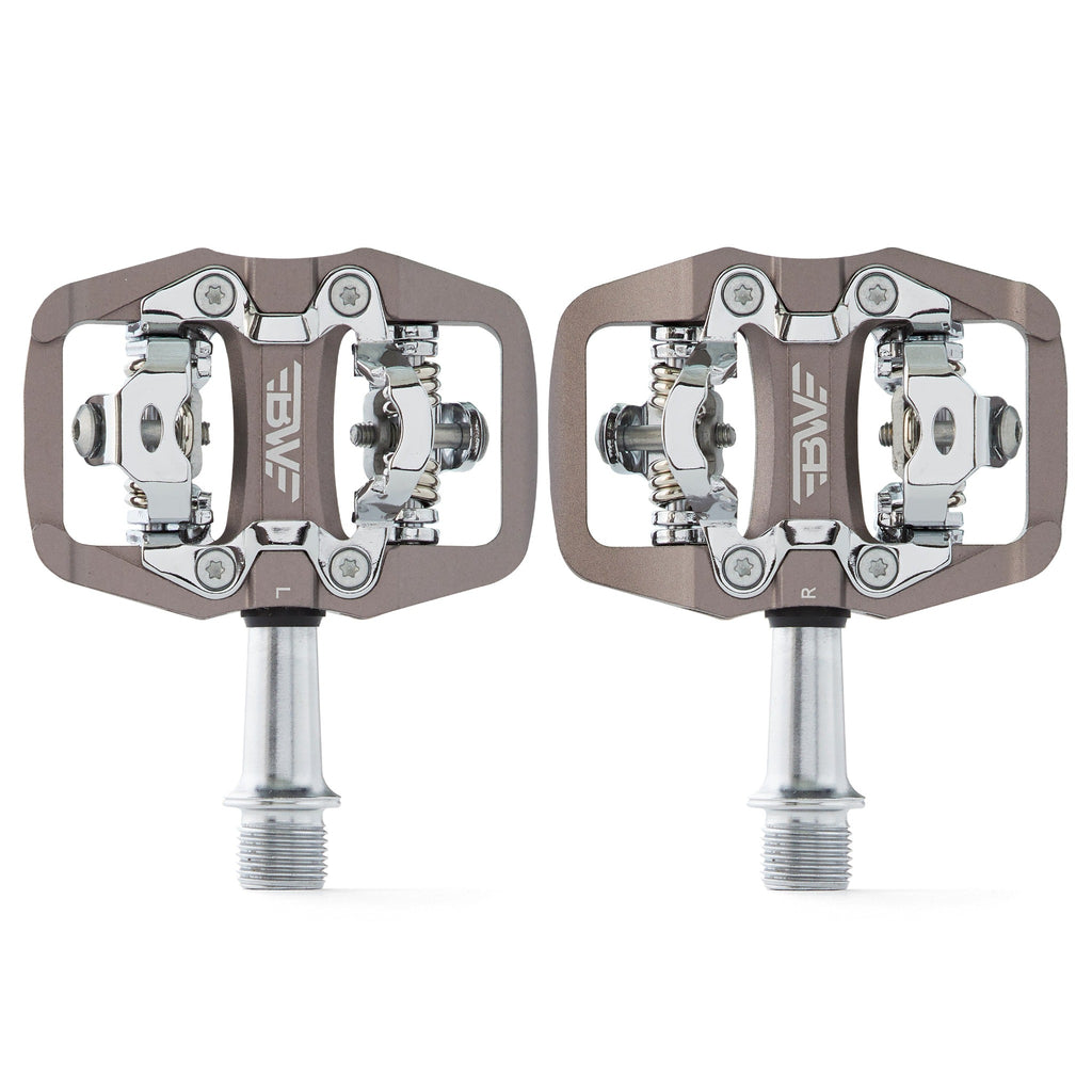 Gray clipless mountain bike pedals, top view on white background. SPD compatible bicycle pedals.