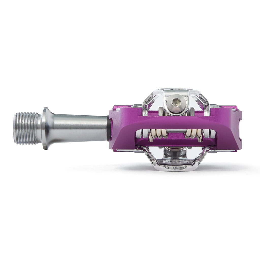 Purple clipless mountain bike pedal, front view on white background. SPD compatible bicycle pedal.