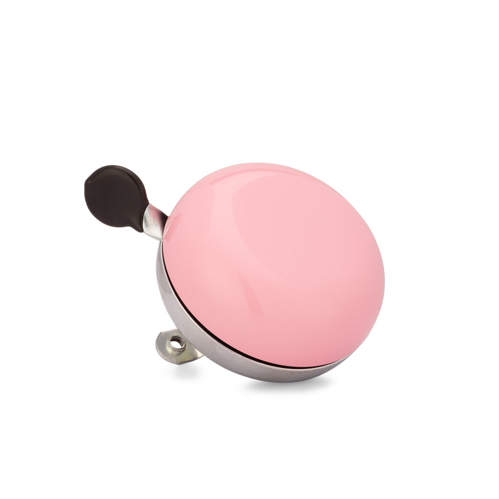 Handlebar bike bell with classic ding dong sound. Color blush pink on a white background. Corner view of vintage style bike bell.