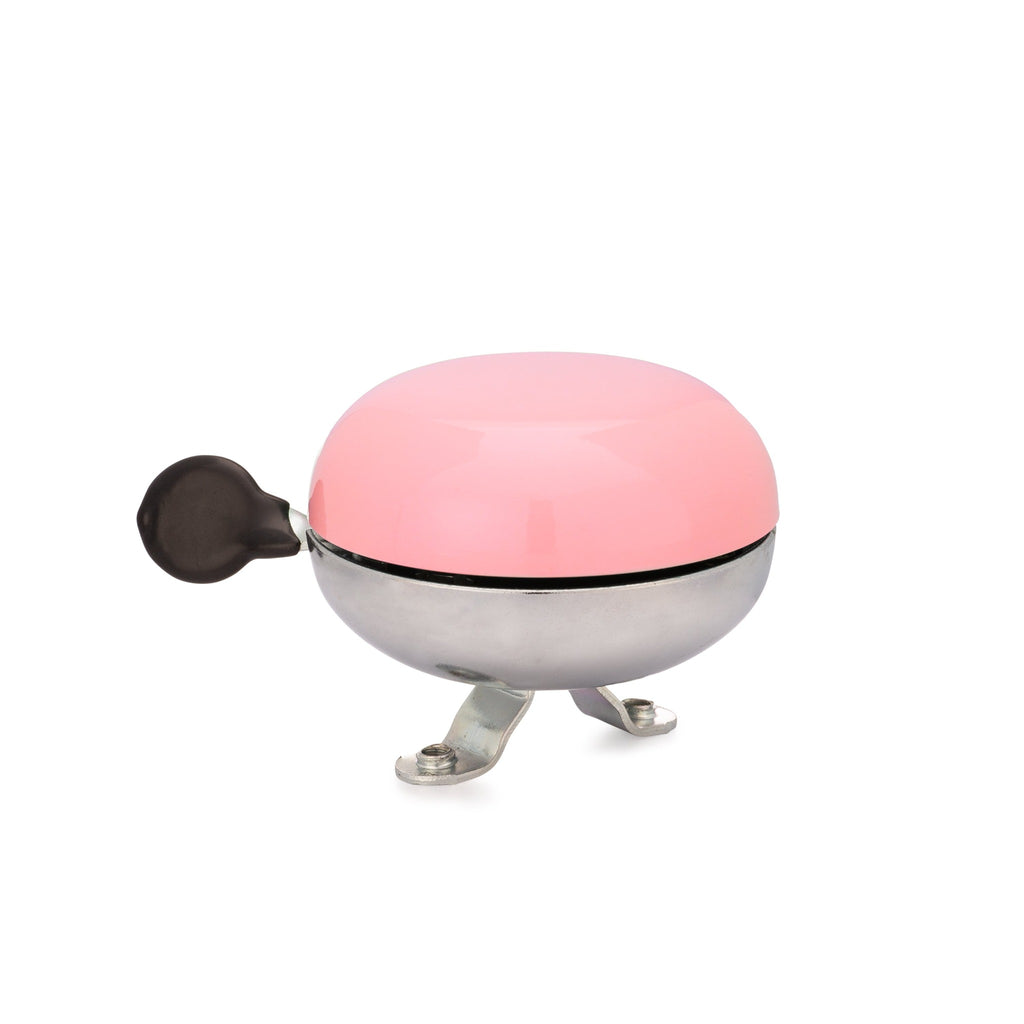 Handlebar bike bell with classic ding dong sound. Color blush pink on a white background. Side view of vintage style bike bell.
