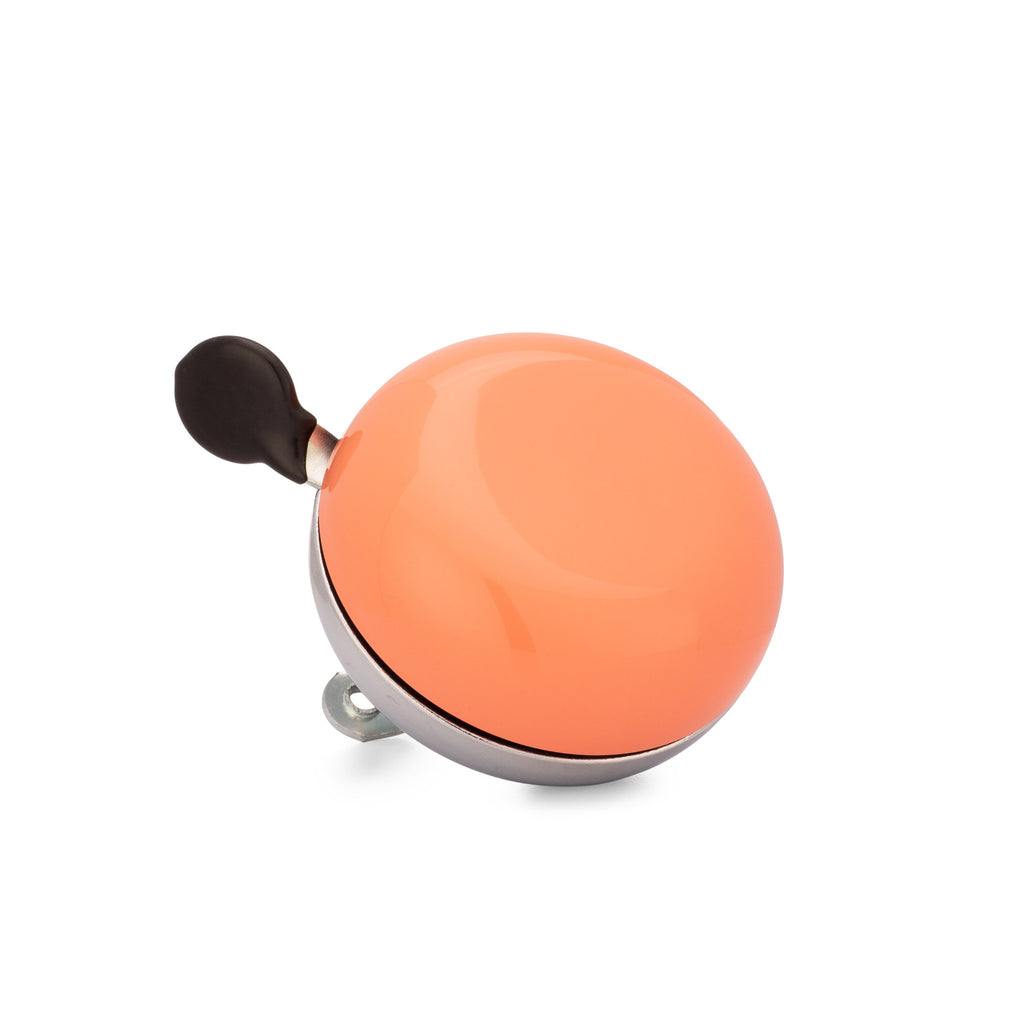 Handlebar bike bell with classic ding dong sound. Color coral on a white background. Corner view of vintage style bike bell.