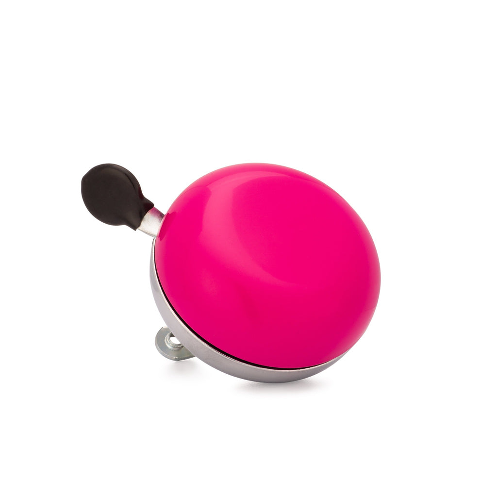 Magenta bike bell with classic ding dong sound. Corner view with white background. Vintage style bike bell.
