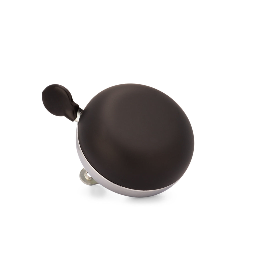 Matte black bike bell with classic ding dong sound. Corner view with white background. Vintage style bike bell.