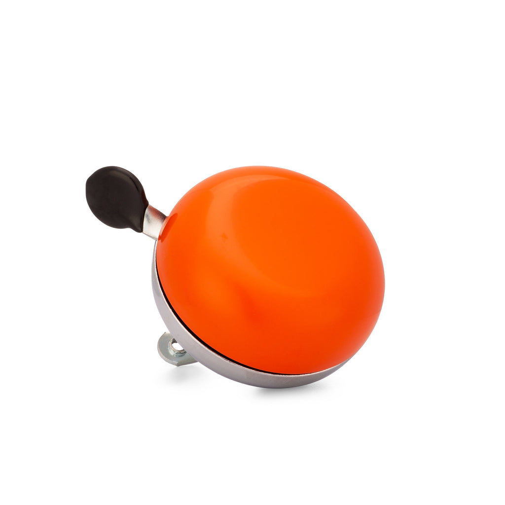 Orange bike bell with classic ding dong sound. Corner view with white background. Vintage style bike bell.