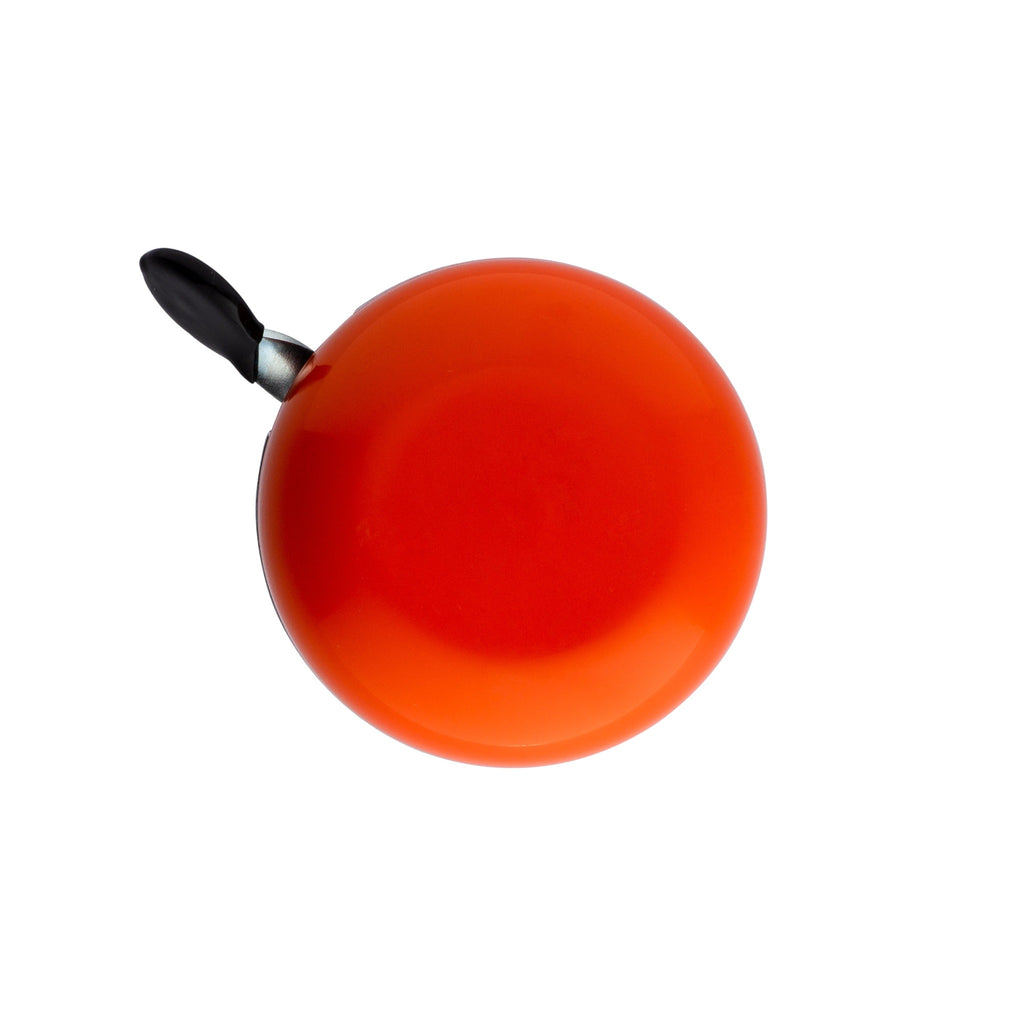 Orange bike bell with classic ding dong sound. Top view with white background. Vintage style bike bell.