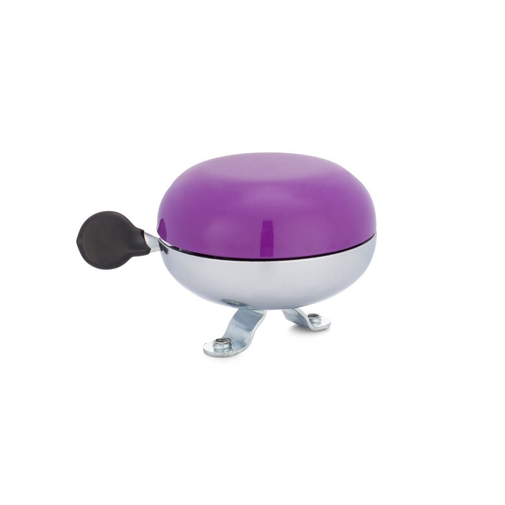 Purple bike bell with classic ding dong sound. Side view with white background. Vintage style bike bell.