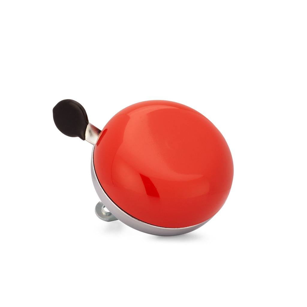 Red bike bell with classic ding dong sound. Corner view with white background. Vintage style bike bell.