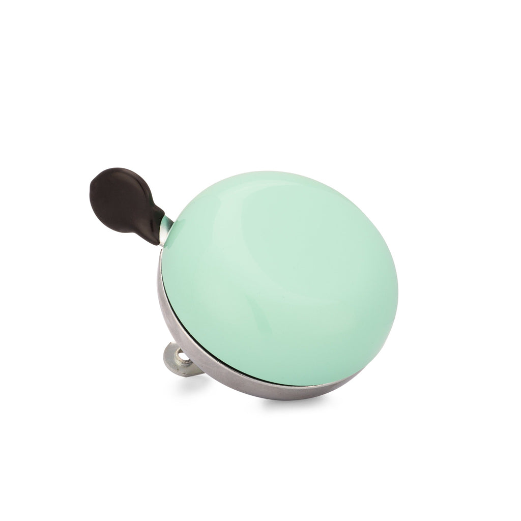 Seafoam green bike bell with classic ding dong sound. Corner view with white background. Vintage style bike bell.