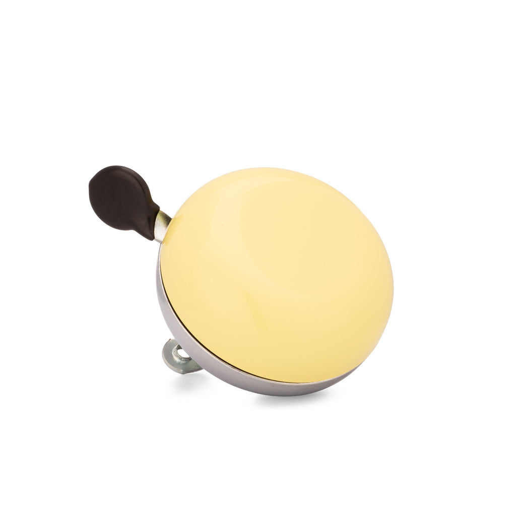 Yellow bike bell with classic ding dong sound. Corner view with white background. Vintage style bike bell.