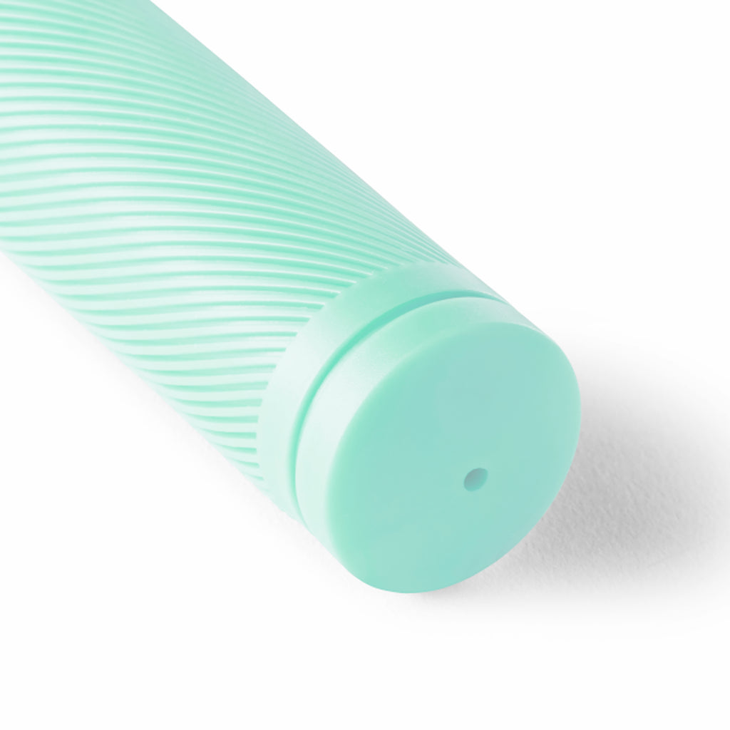 Close up of seafoam bicycle grip with a white background.