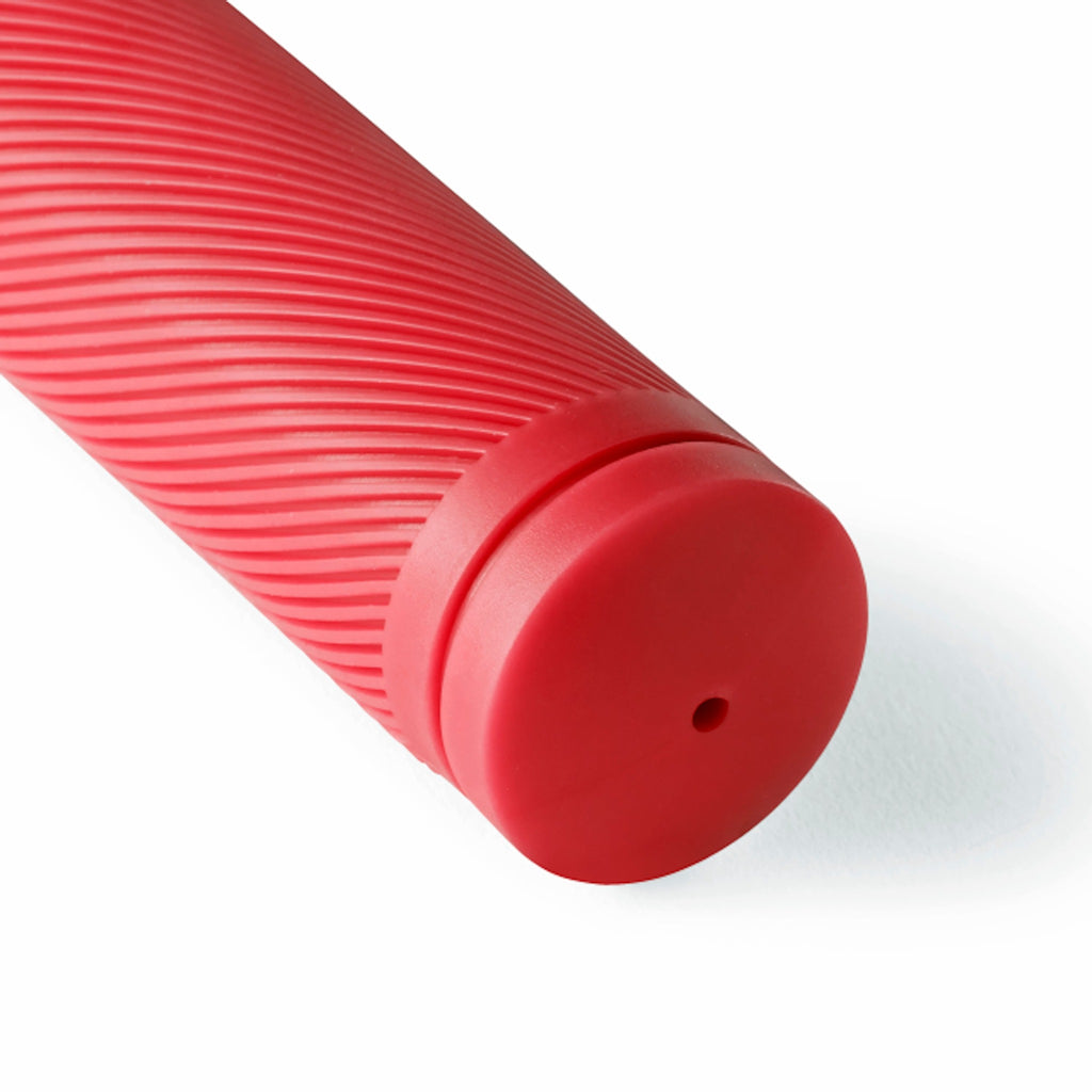 Close up of red bicycle grip with a white background.