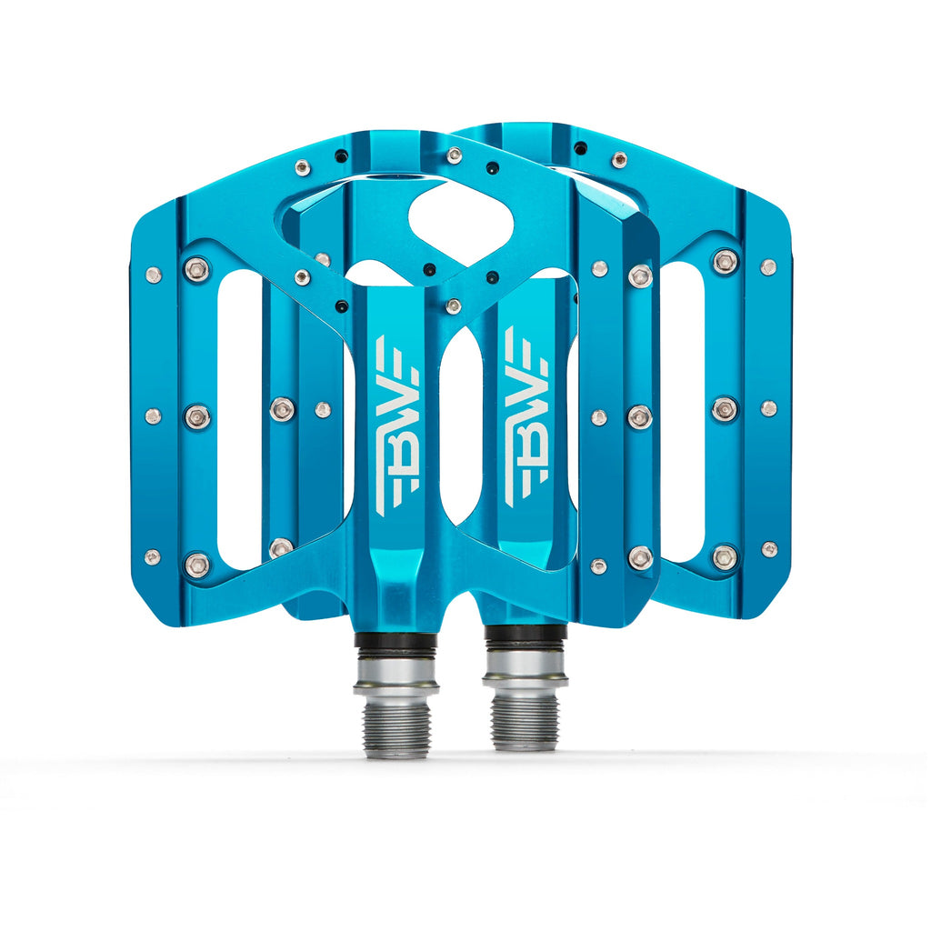 Light blue mountain bike pedals on white background. Top view of light blue mountain bike pedals.