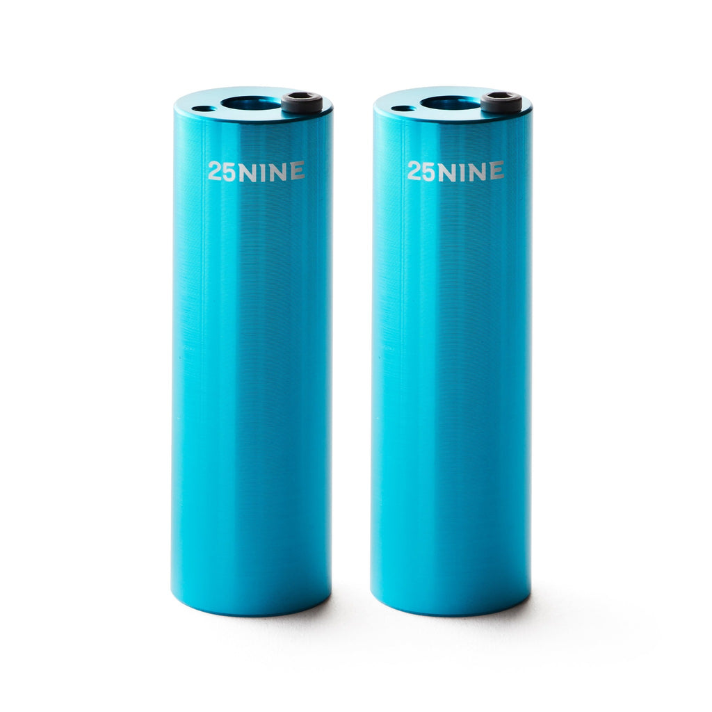 Set of light blue bmx pegs with white background.