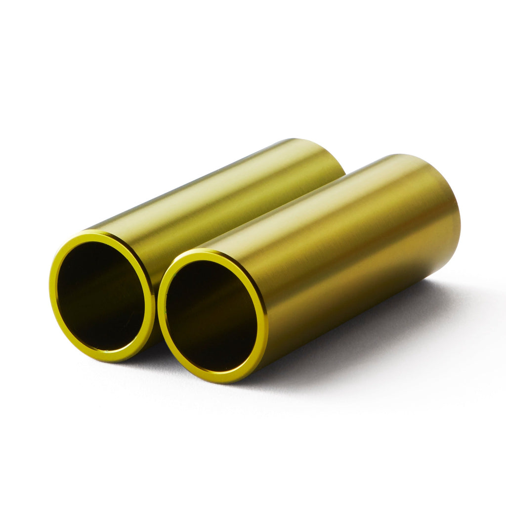 Set of light green bmx pegs with white background.
