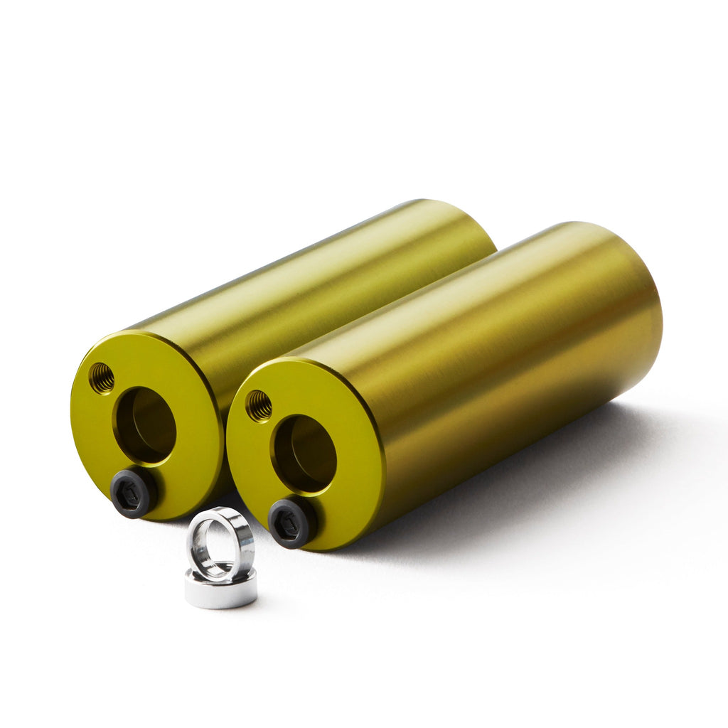 Set of light green bmx pegs with white background.