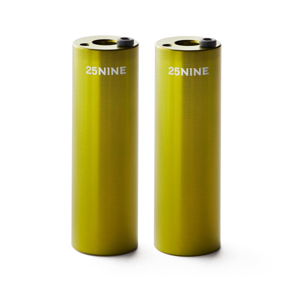 Set of light green bmx pegs with white background.