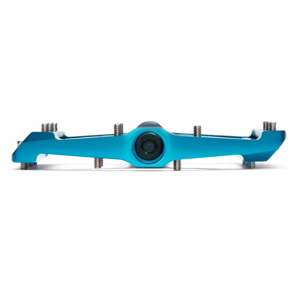 Light blue mountain bike pedal on white background. Side view of mountain bike pedal.