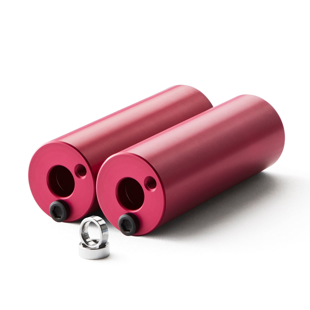 Set of pink bmx pegs with white background.