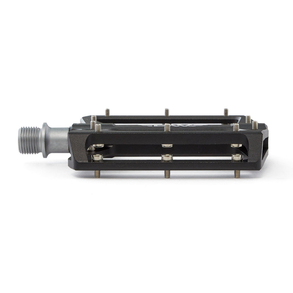 Large platform mountain bike pedal with replaceable traction pins. Single black pedal viewed from the side on a white background.