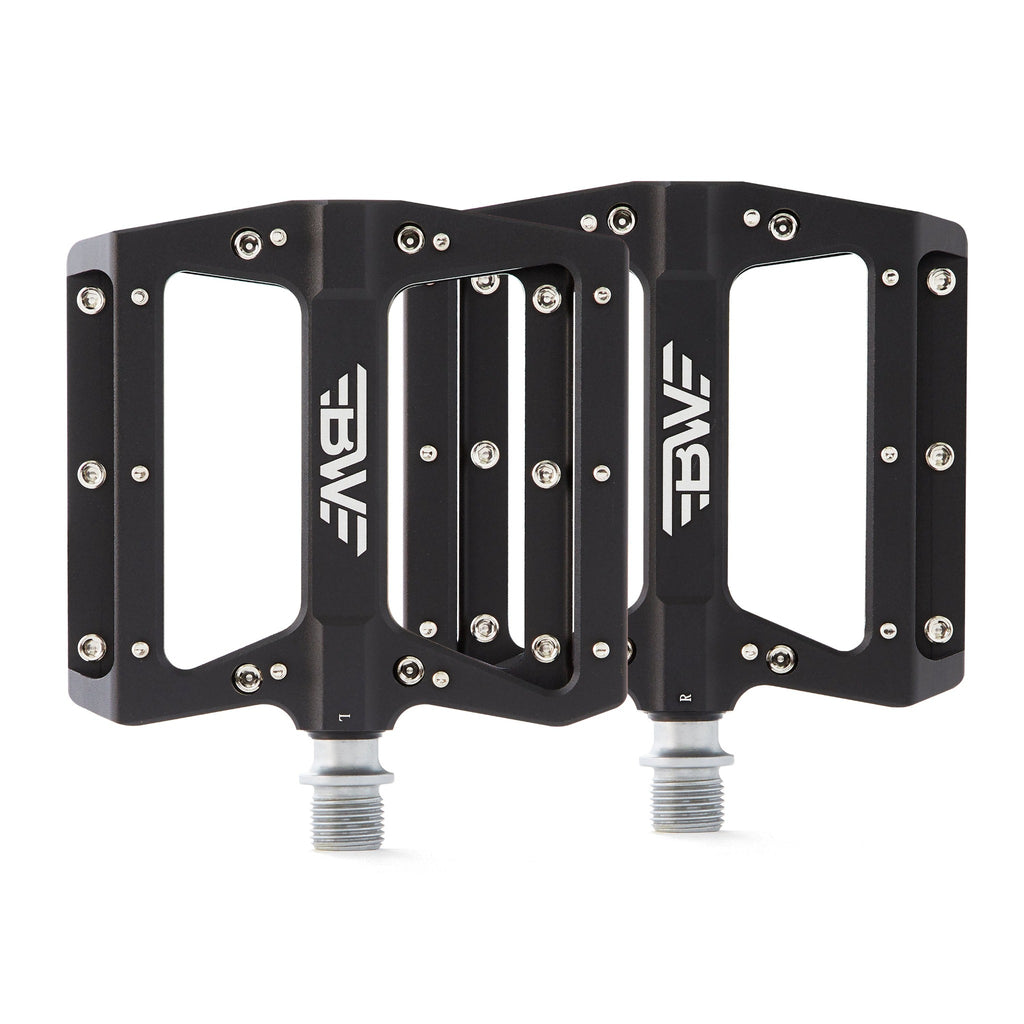 large platform mountain bike pedals with replaceable traction pins.  Black pedals viewed from top on white background.