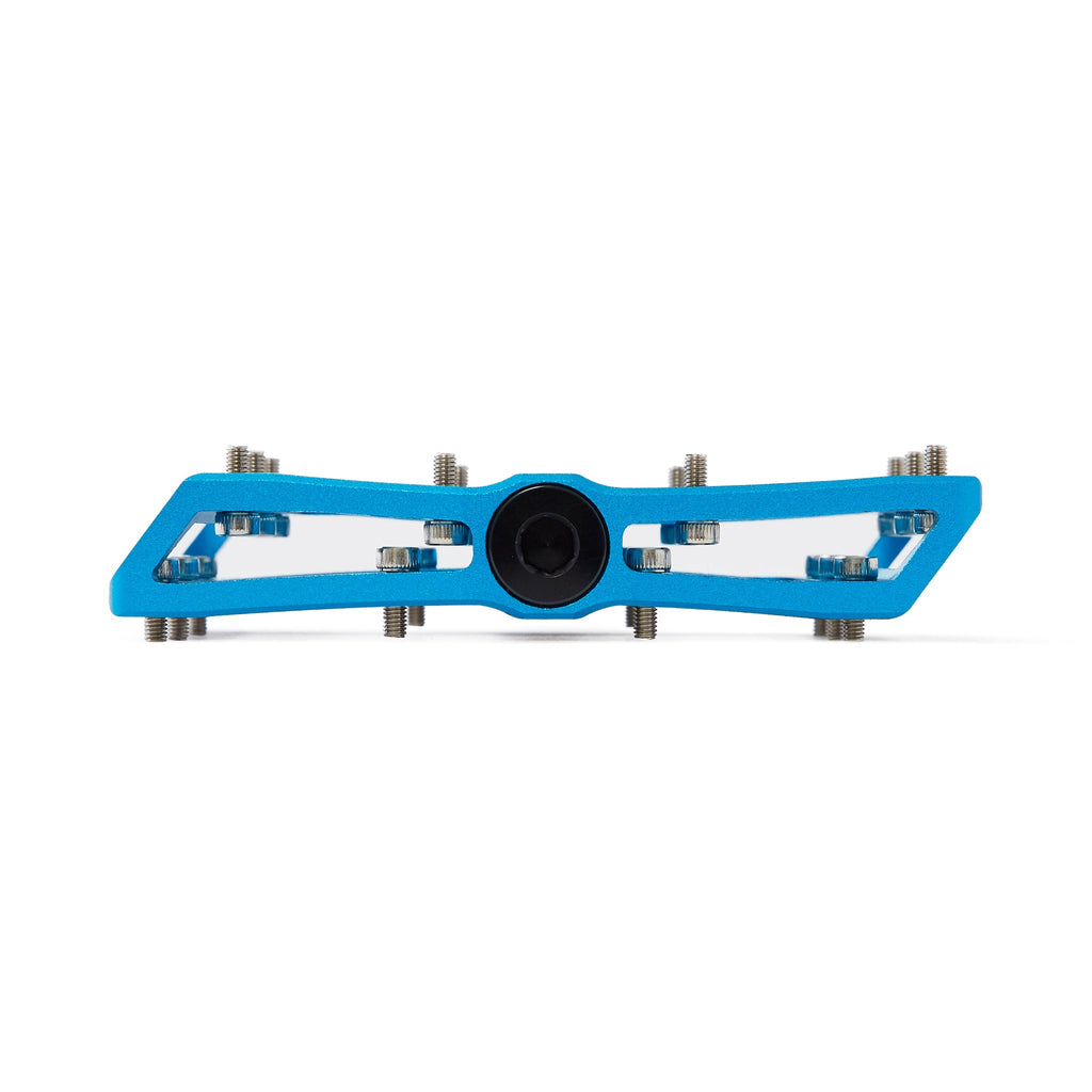 Large platform mountain bike pedal with replaceable traction pins. Blue mountain bike pedal viewed from the side on a white background.
