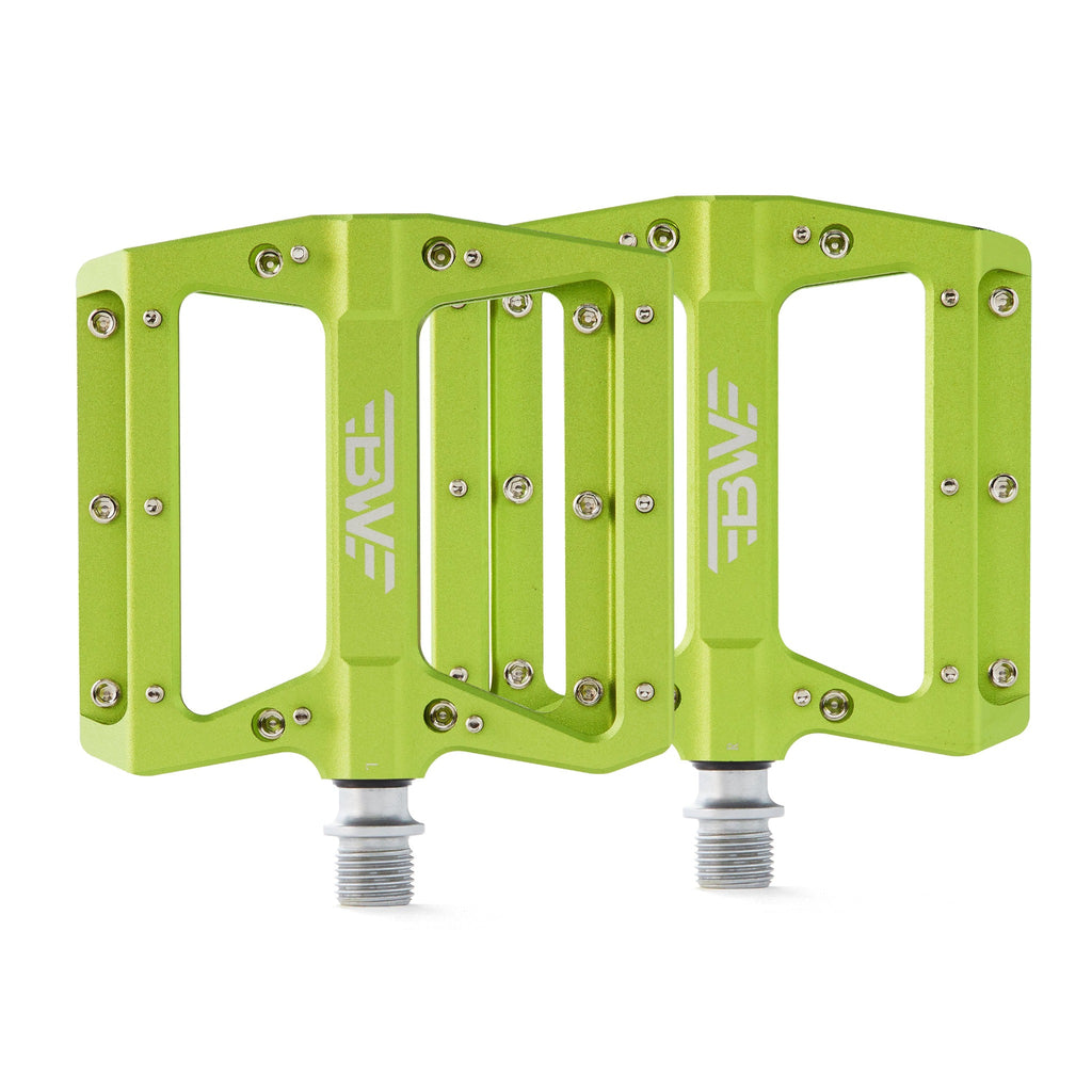 Large platform mountain bike pedals with replaceable traction pins. Green mountain bike pedals viewed from the top on a white background.