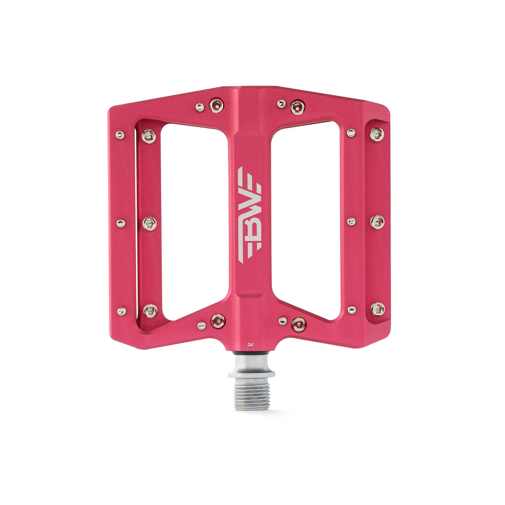 Large platform mountain bike pedal with replaceable traction pins. Pink mountain bike pedal viewed from the top on a white background.
