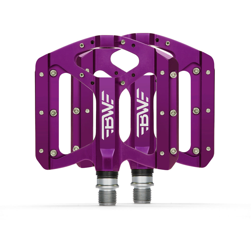 Purple mountain bike pedals on white background.